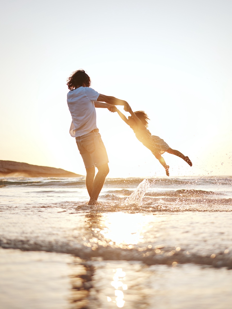 Girl child, swing and father by ocean, sunset and speed for game, holding hands or waves in summer. Young female kid, dad and spin in air, sand or happy for family bonding, love or care in sunshine